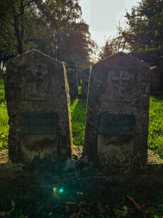 Fotografie zweier Grabsteine mit neuen Namensschildern (links: unbekannter russischer Soldat; rechts: Izot Prianikow) auf dem Ehrenfriedhof Haus Spital