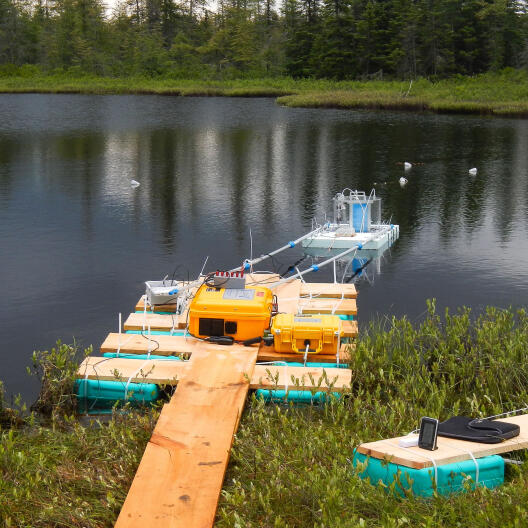 A jetty in a lake with floating measurement setup.
