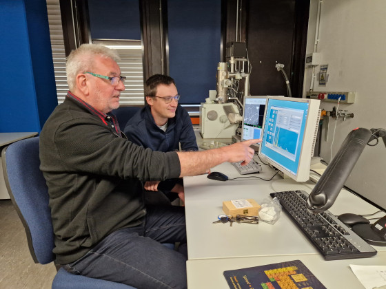 Addi Bischoff (left) and Markus Patzek examine the artefacts using a scanning electron microscope.<address>© Uni MS - Institut für Planetologie</address>