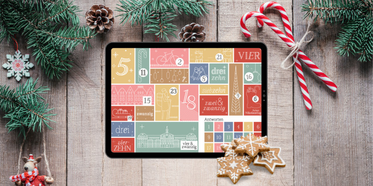 Bild von einem Tablet auf dem der Adventskalender der Universität Münster geöffnet ist.<address>© Uni MS</address>